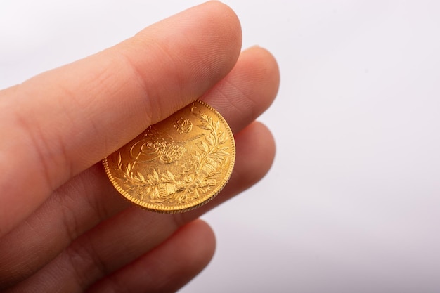 Turkish Ottoman style gold coin in hand