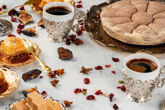 Turkish pastries and scattered dry fruits on table