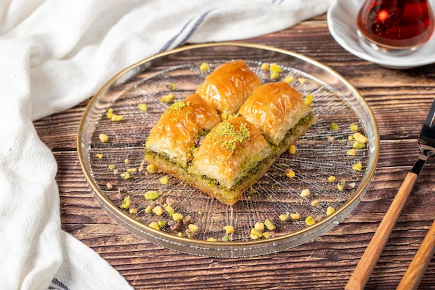 Photo turkish pistachio baklava turkish cuisine delicacies baklava on wood background close up