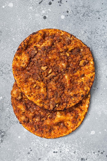 Turkish pizza lahmacun on kitchen table Gray background Top view