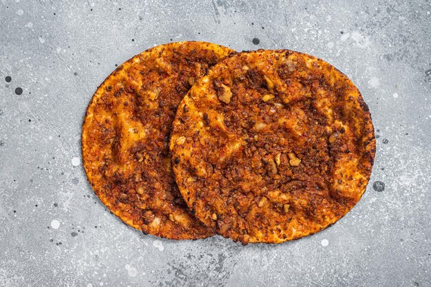 Turkish pizza lahmacun on kitchen table Gray background Top view