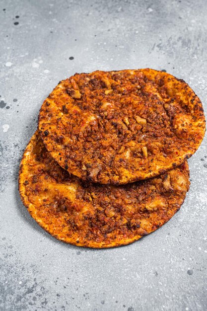 Turkish pizza lahmacun on kitchen table Gray background Top view