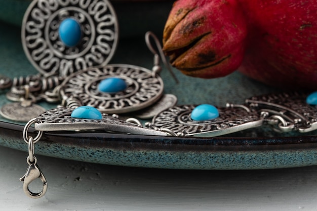 Turkish pomegranate fruit with turkish jewellery and open pomegranate, side view