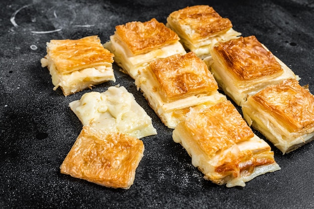 Turkish Su Boregi Tabla borek or burek with cheese Black background Top view