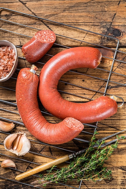 Turkish Sucuk beef meat sausage on a grill Wooden background Top view