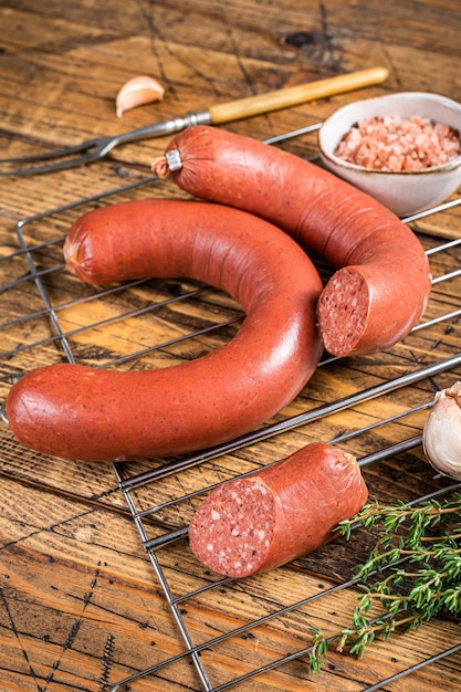 Turkish Sucuk beef meat sausage on a grill Wooden background Top view