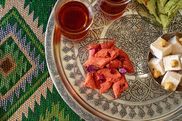 Turkish sweet baklava on metal tray with turkish tea