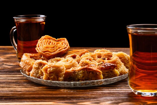 Turkish sweet baklava on plate with Turkish tea.