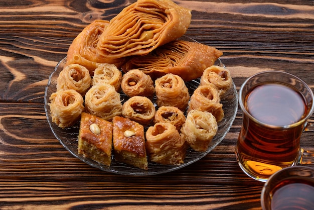 Turkish sweet baklava on plate with turkish tea.