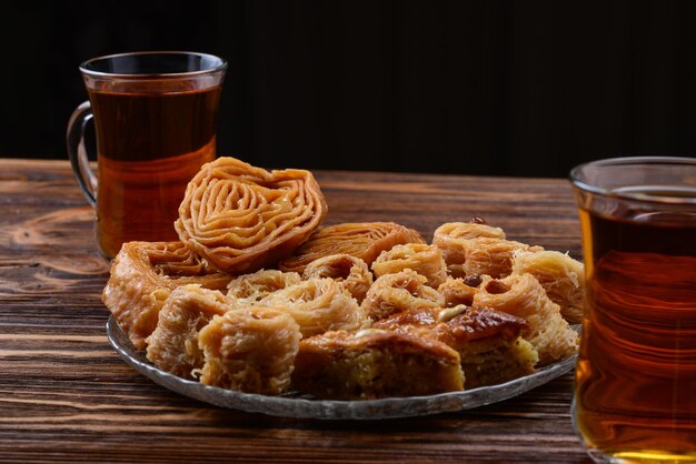 Turkish sweet baklava on plate with Turkish tea