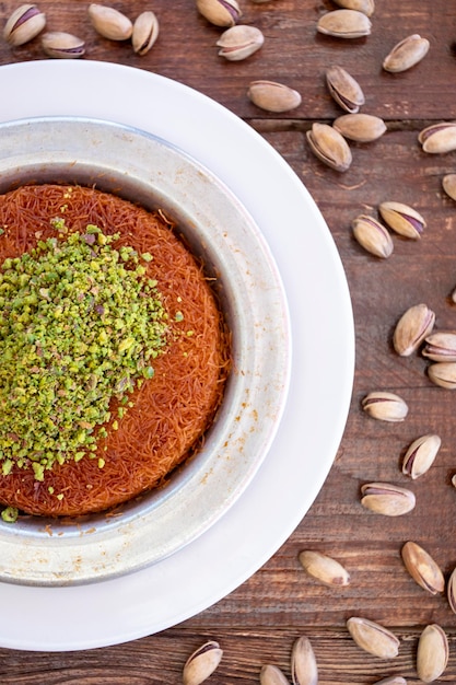 Turkish sweetness kunefe on wooden table