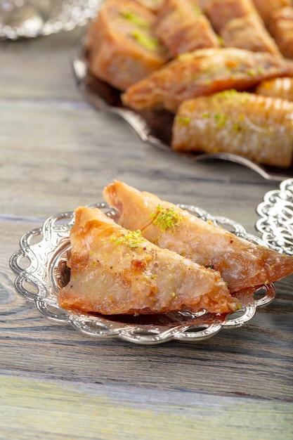 Turkish sweets baklava and metal oriental tray on wooden