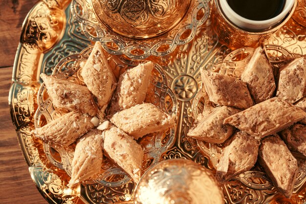 Turkish sweets with coffee on a wooden table