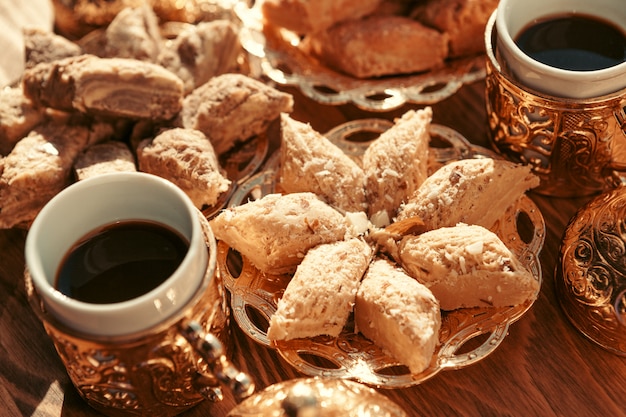 Turkish sweets with coffee on a wooden table