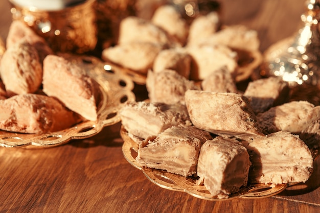 Turkish sweets with coffee on a wooden table