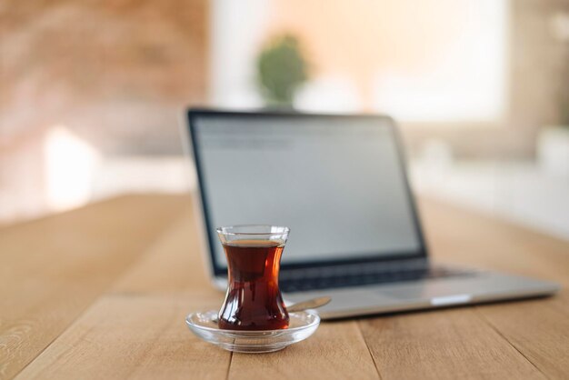 Turkish tea and laptop on table