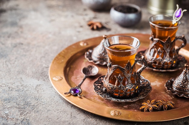 Turkish tea in traditional glass on tray closeup