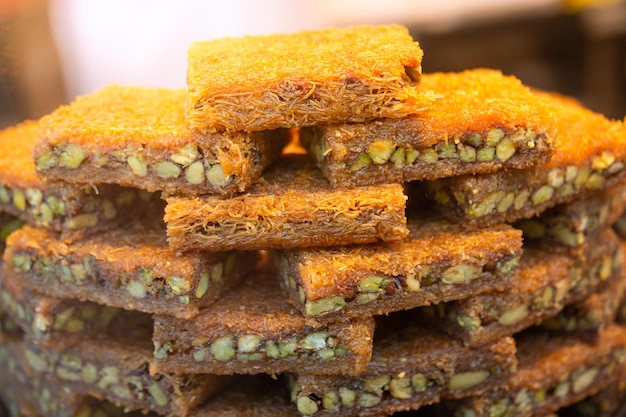 turkish traditional dessert kadayif baked in syrup served with nut powder