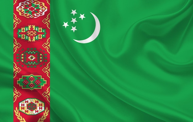 Photo turkmenistan country flag on wavy silk fabric background panorama - illustration