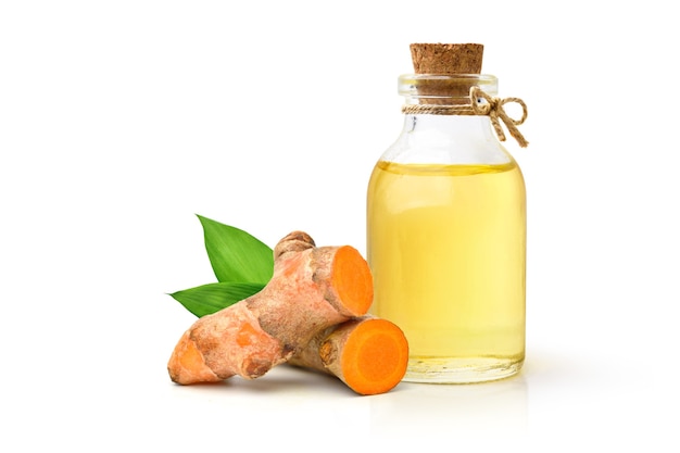 Turmeric (Curcuma longa Linn) essential oil with  rhizome and leaves isolated on white background.