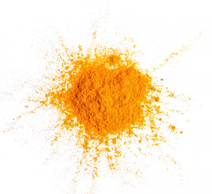 Photo turmeric (curcuma) powder pile isolated on white surface, top view