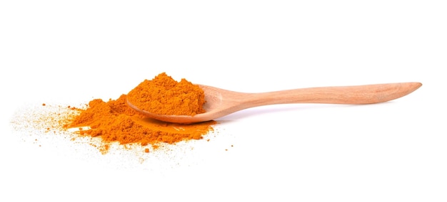 Turmeric Curcuma powder in wooden spoon on white background