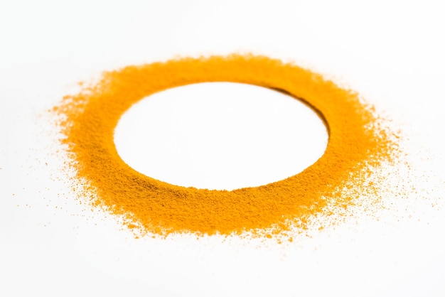 Turmeric or Haldi powder on the white background forming ring shape