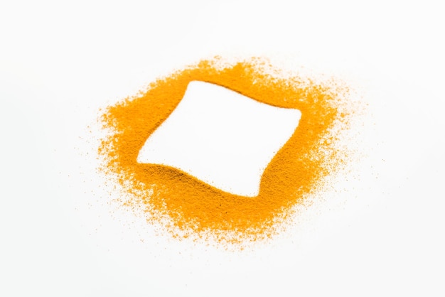 Turmeric or Haldi powder on the white background forming ring shape