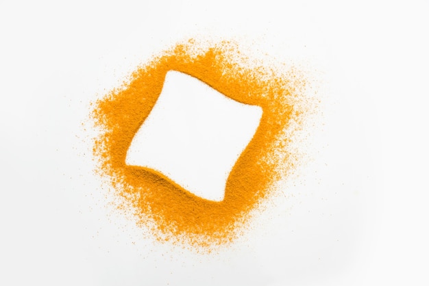 Turmeric or Haldi powder on the white background forming ring shape