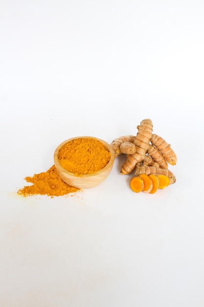 turmeric ingredients and powder in a wooden bowl