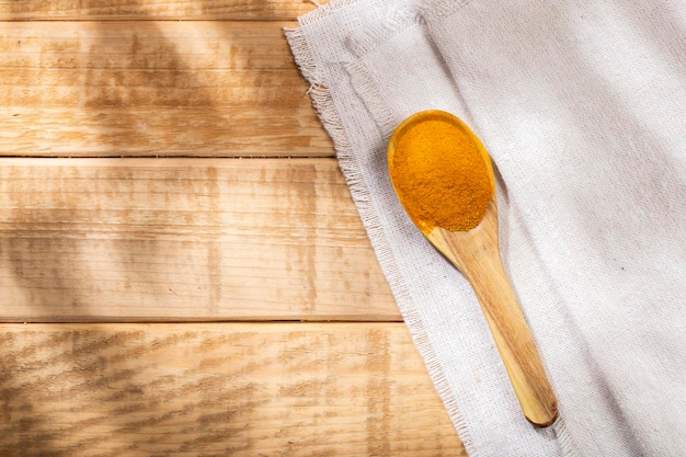 Turmeric powder in bowl on the table top view