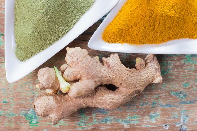 turmeric powder and ginger root on the table