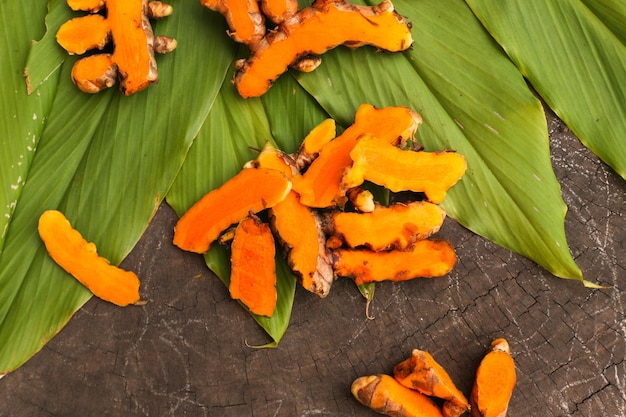 Turmeric powder and a glass of honey are isolated on old rustic wood table backgrounda beauty and s