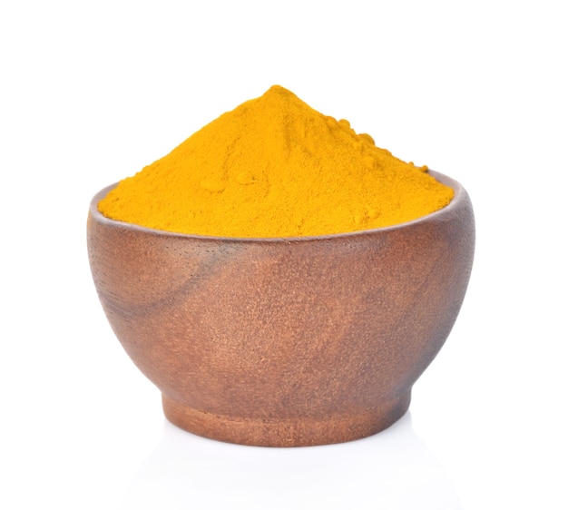 Photo turmeric powder isolated on white background.