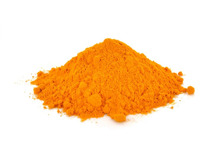 Photo turmeric powder isolated on white background.