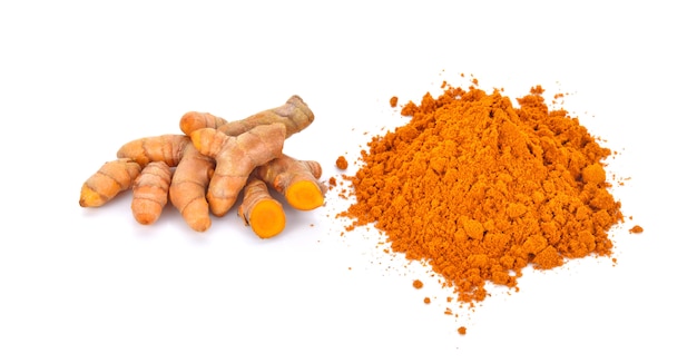 Turmeric powder with turmeric root isolated on white