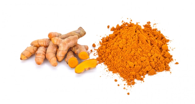 Turmeric roots and turmeric powder on white background