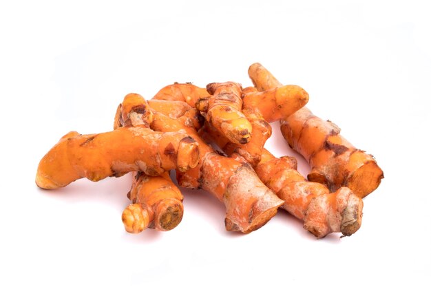 Turmeric roots on white background.