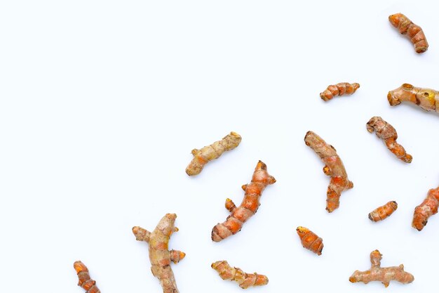 Turmeric roots on white background