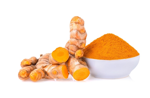 Turmeric roots with turmeric powder isolated on white background