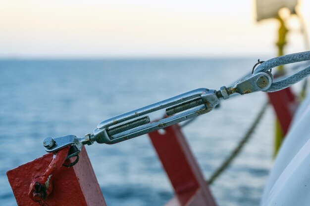 Photo turn buckle securing a life raft onboard a construction work barge while in operation at oil field