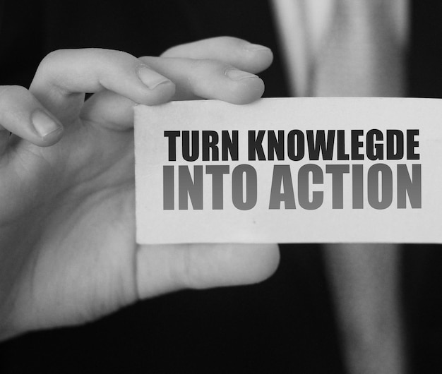 Turn Knowledge Into Action card in businessman hand Business concept