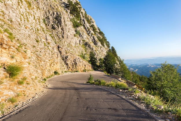 Turn of the road in mountains of Montenegro at sunrise