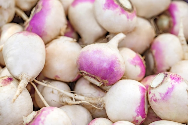 Turnips whole in bulk on supermarket selective focus