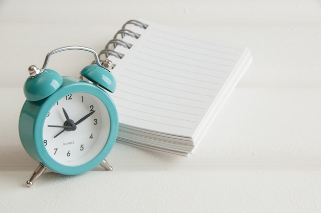 Turquoise alarm clock on white