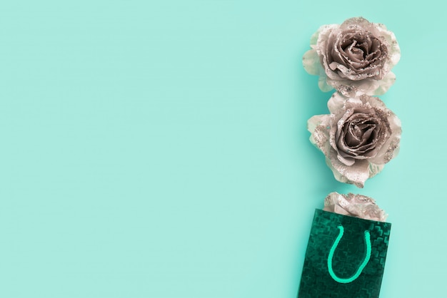 turquoise background for text with silver glittering roses. 