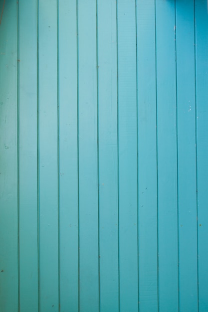 Turquoise bright colored old vintage wood with vertical boards