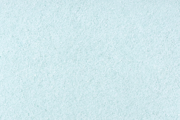 Turquoise colored sand background texture. Full frame