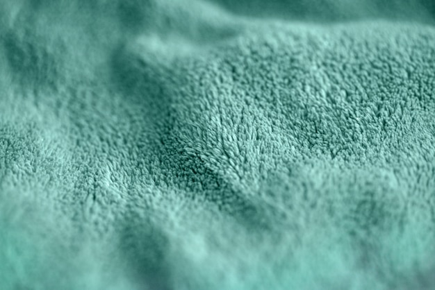 毛皮の豪華な滑らかな生地のターコイズブルーの繊細な柔らかい背景。柔らかなふわふわ毛布繊維のテクスチャ