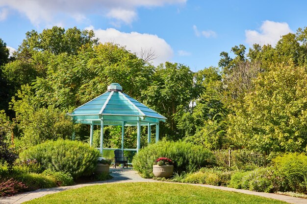 Turquoise Gazebo in Lush Park with Stone Path and Sunny Sky